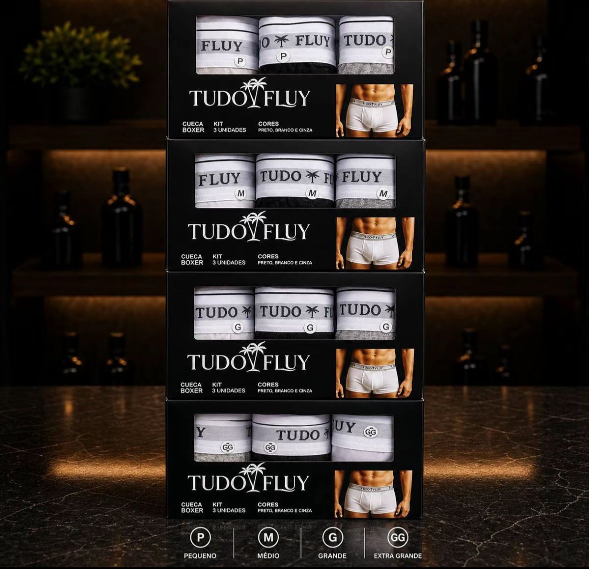 Caixas do kit de cueca boxer Tudo Fluy empilhadas nos tamanhos P, M, G e GG